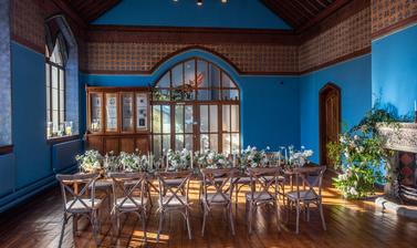 A long table set up in the Westwood Room for a wedding breakfast