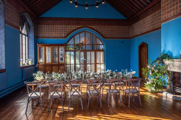 A long table set up in the Westwood Room for a wedding breakfast