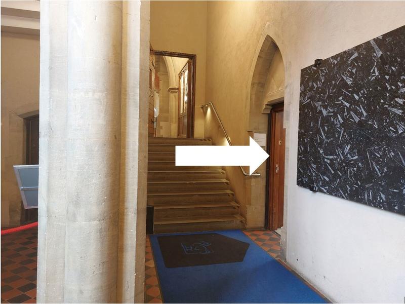 A short corridor with an arrow pointing into a corridor toward the right