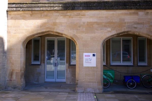 A courtyard with two stone arches, through which is the accessible entrance to the Museum